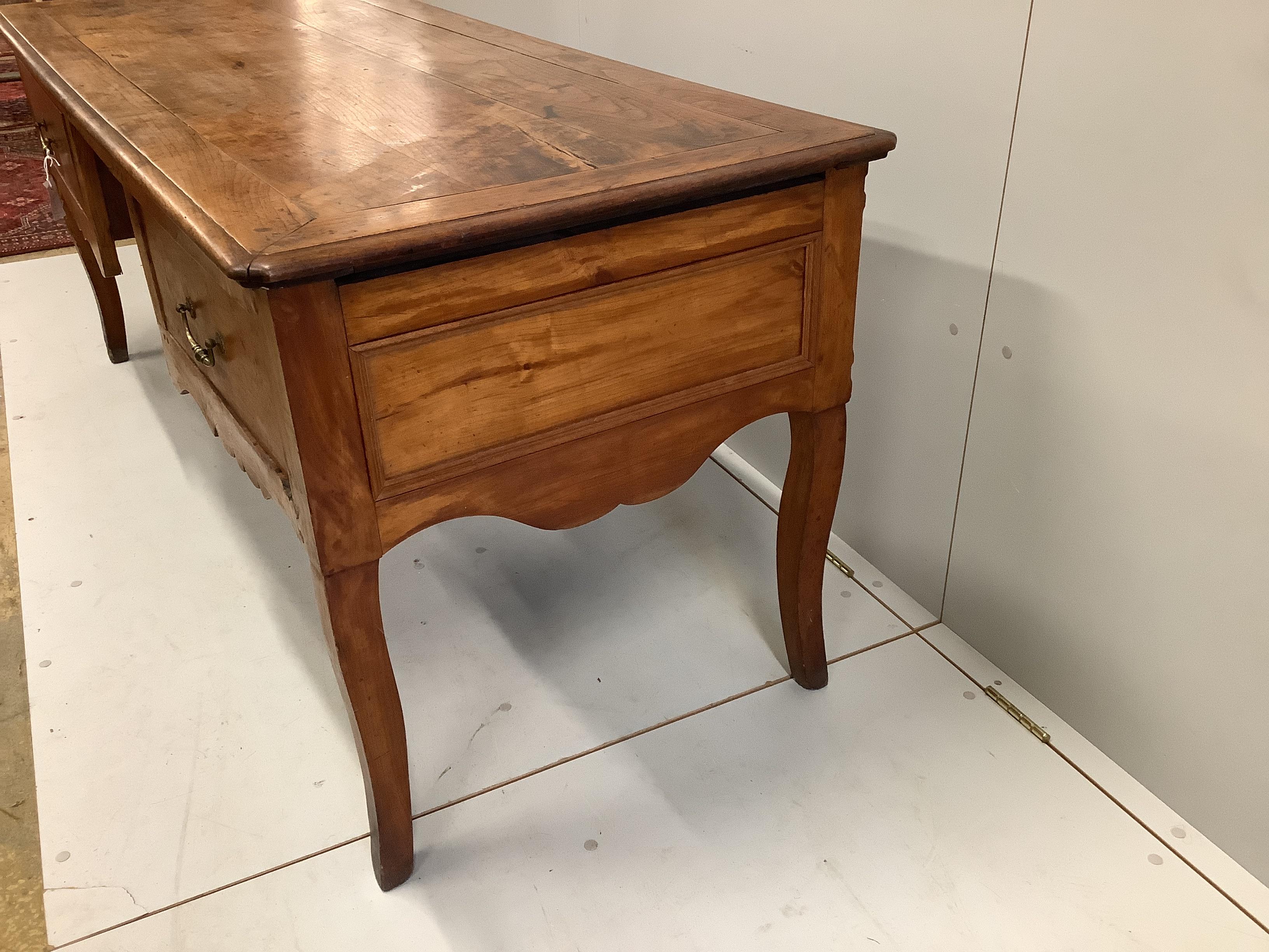 A late 18th century French Provincial fruitwood kneehole table, width 178cm, depth 70cm, height 74cm